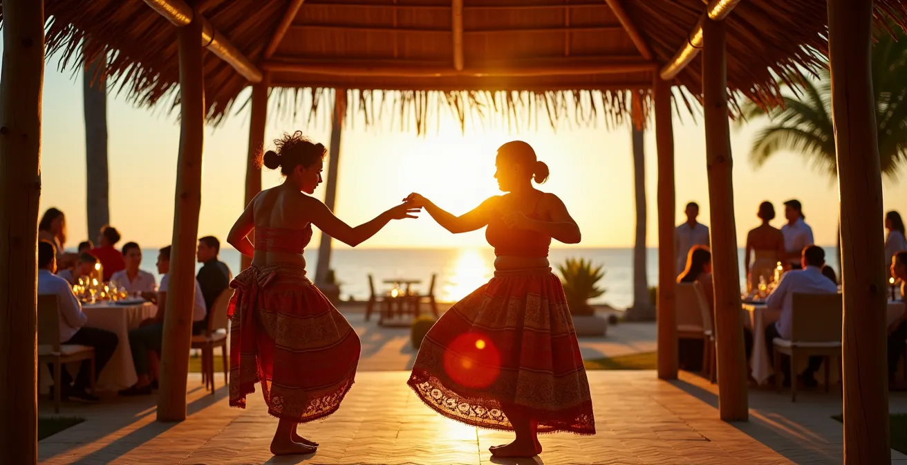 Traditional Filipino dancers in colorful indigenous costumes performing at sunset on luxury resort beach pavilion