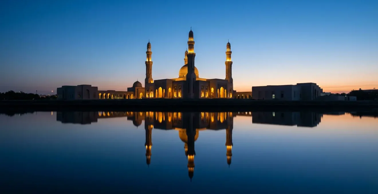 The Sultan Hassanal Bolkiah Mosque with its illuminated minarets reflecting perfectly on the water during the golden hour at dusk.